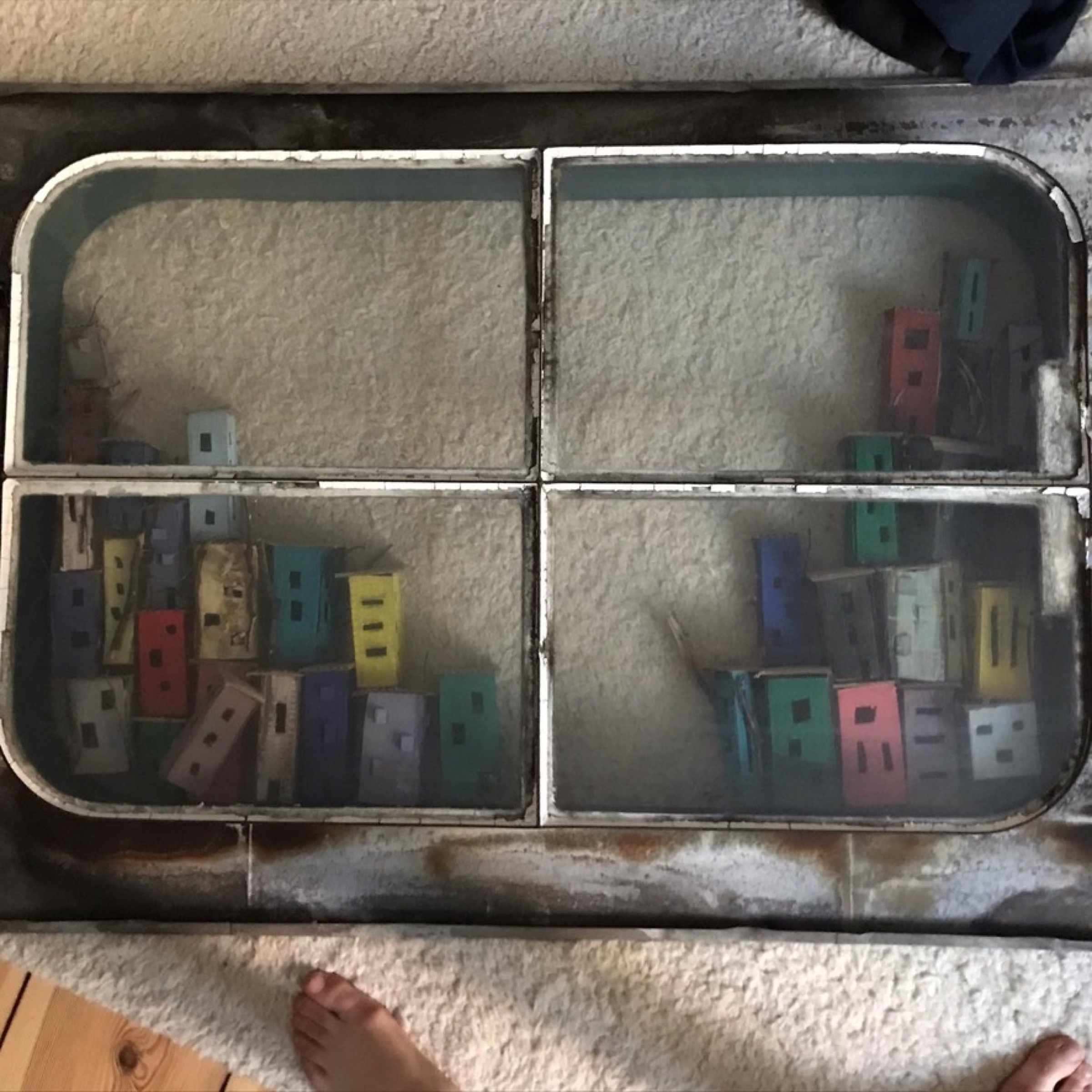 Miniature houses arranged behind the skylight glass