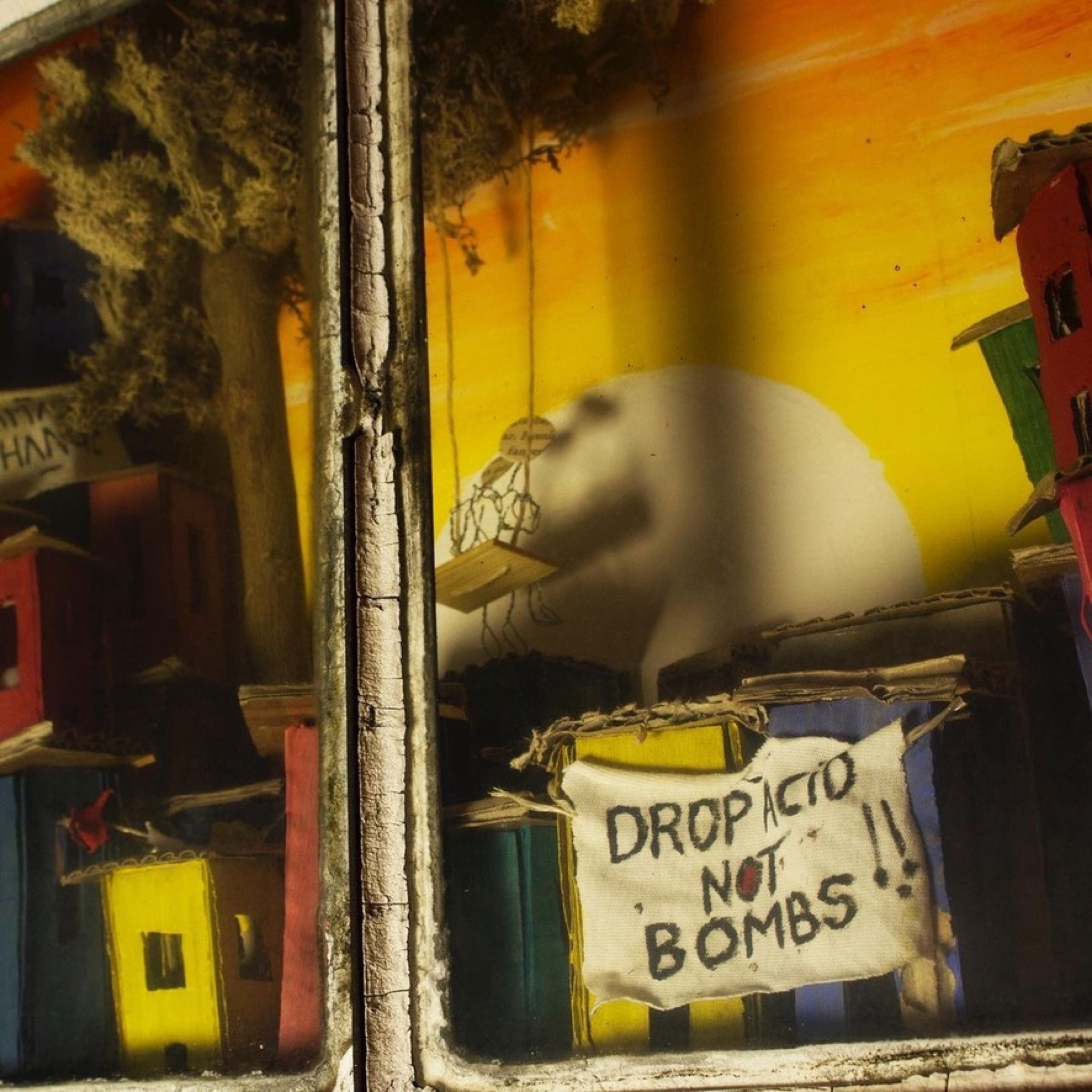 Drop acid not bombs banner within the miniature city