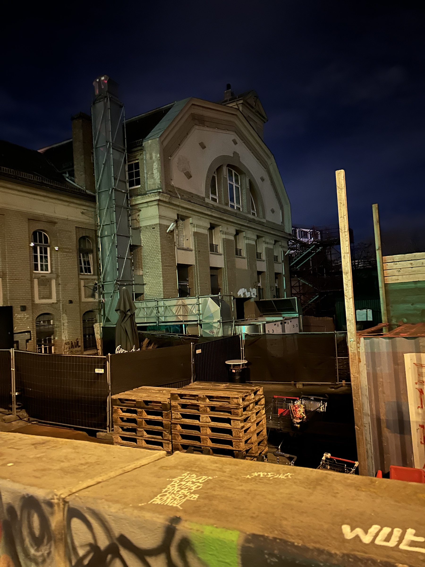 Close view of Club OST and its surrounding construction barriers at night