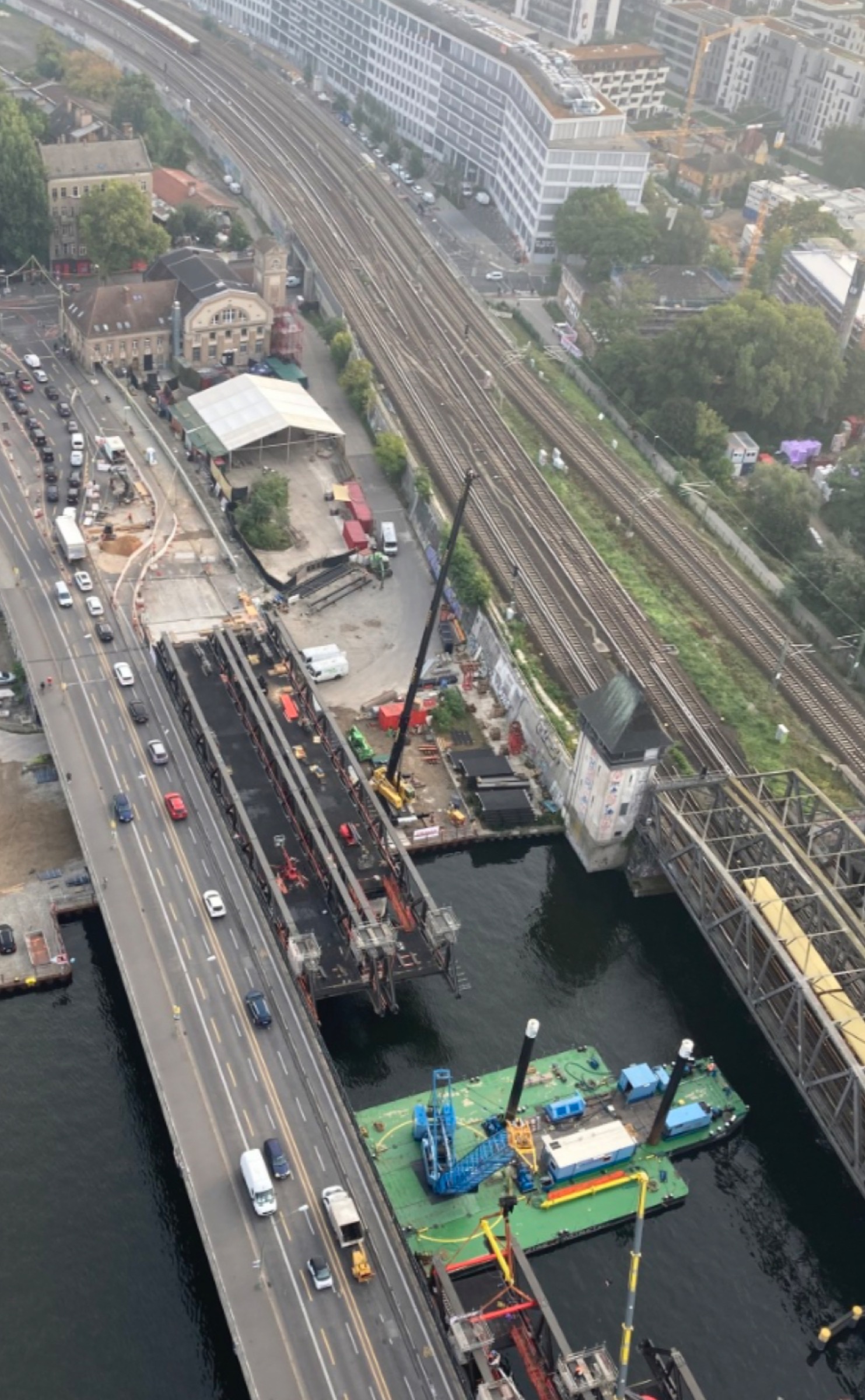 Aerial view of the A100 construction area, Elsenbrücke, railway lines, river, and Club OST surroundings