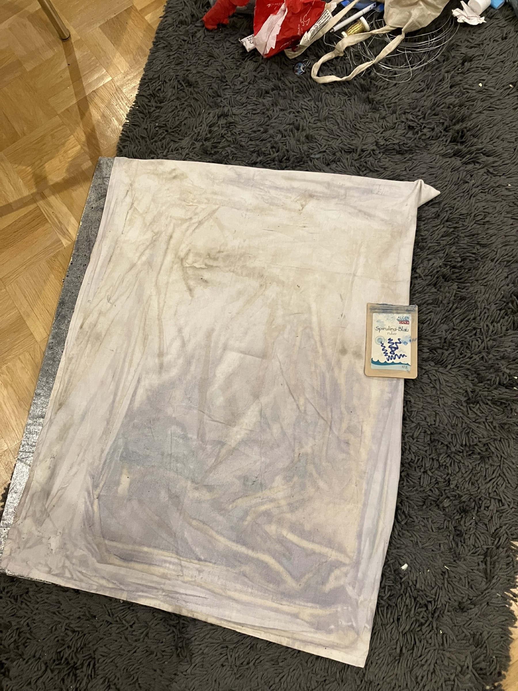 Blue algae being prepared to colour the artwork background