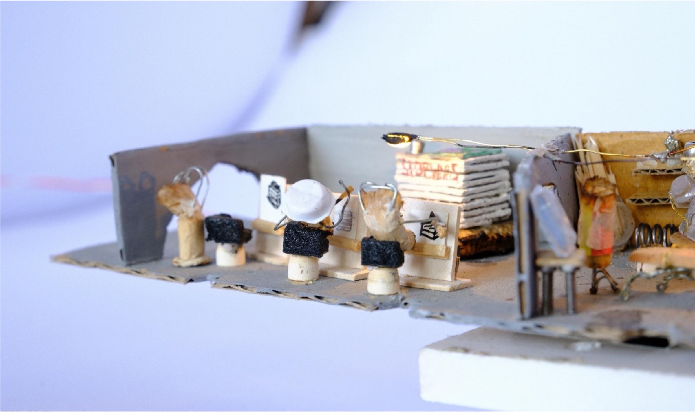 Miniature painters recreating STOP WARS inside the atelier