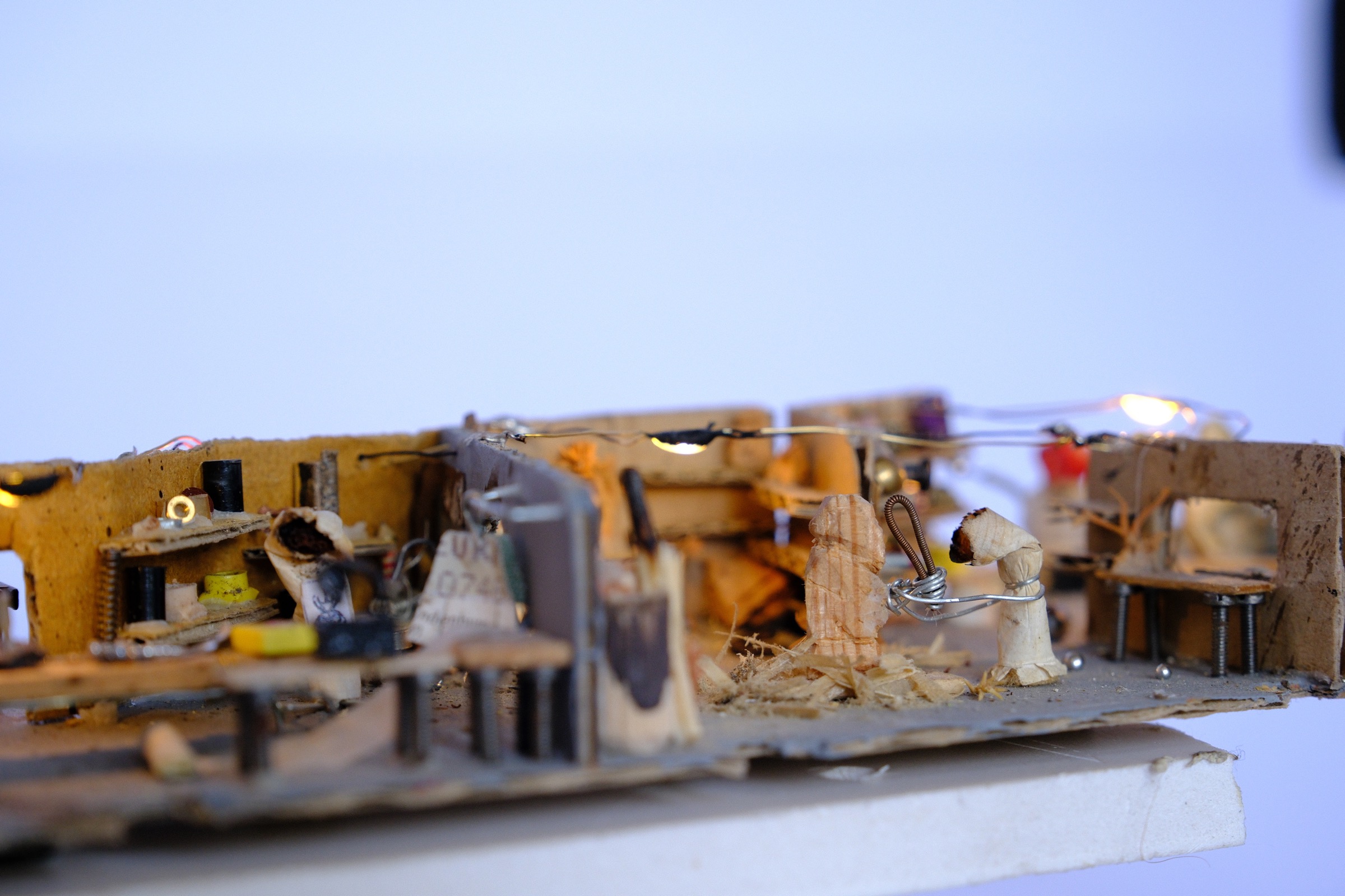 Cigarette figure working with wood in the studio