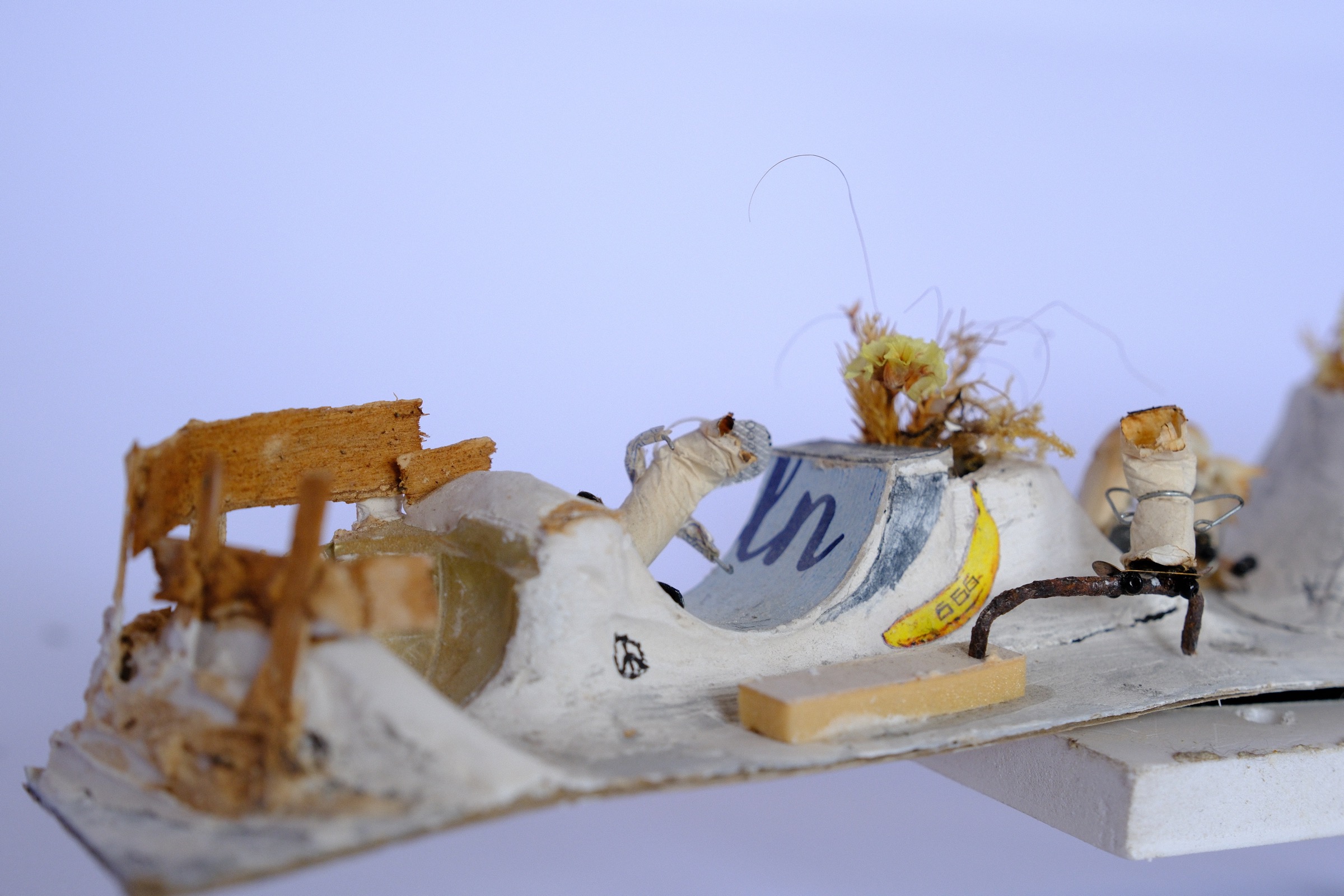 Cigarette figures skating on the halfpipe and grinding inside the miniature skate park