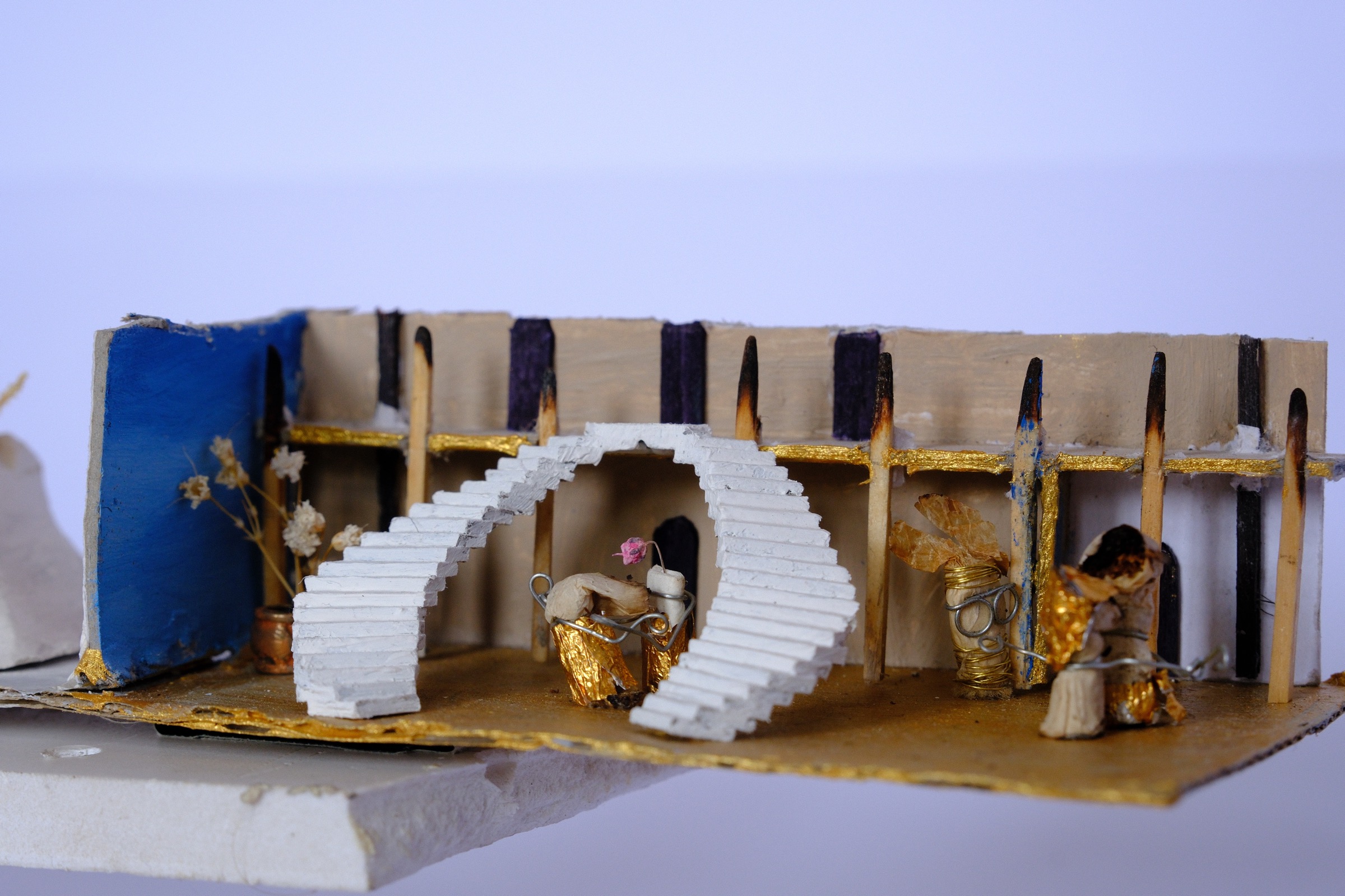 Cigarette figures in golden dresses dancing inside the miniature ballroom